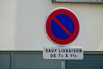 Close-up of road sign on wall