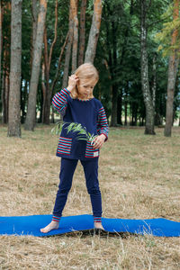 Environmental education for kids. little girl holding young plant in hands 