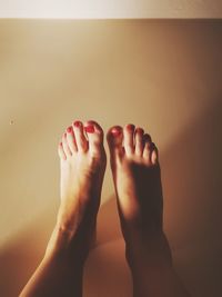 Low section of woman relaxing on floor