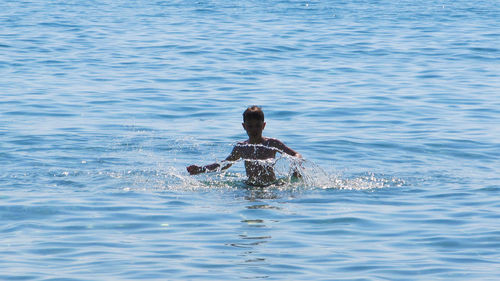 Woman jumping in water