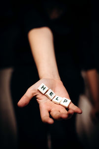 Girl asking for help. girl stretches out her hands with the word help in her palms