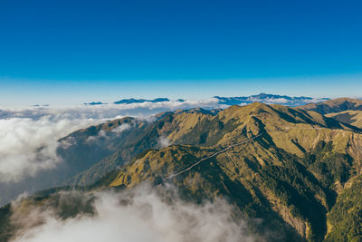 Scenic view of mountains against clear blue sky