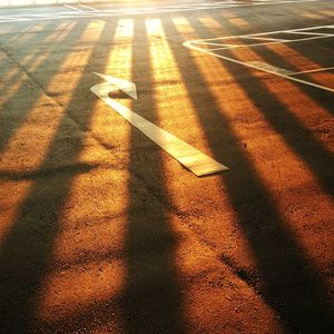 High angle view of shadow on road at sunset