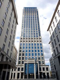 Low angle view of modern buildings against sky in city