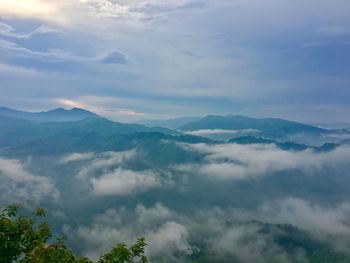 Scenic view of mountains against cloudy sky