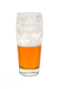 Close-up of beer glass against white background