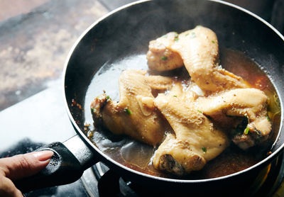 High angle view of chicken meat in cooking pan