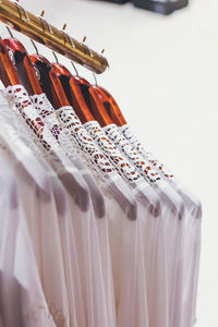 Close-up of clothes hanging against white background