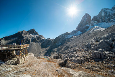 Scenic view of mountains against blue sky