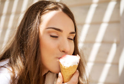 Close-up portrait of woman holding ice cream