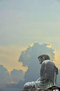 Superimposed of the great buddha of kamakura town, japan with dramatic and peaceful clouds.