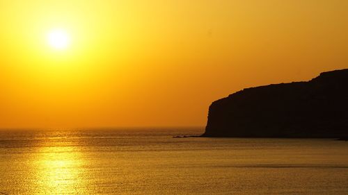 Scenic view of sea against romantic sky at sunset