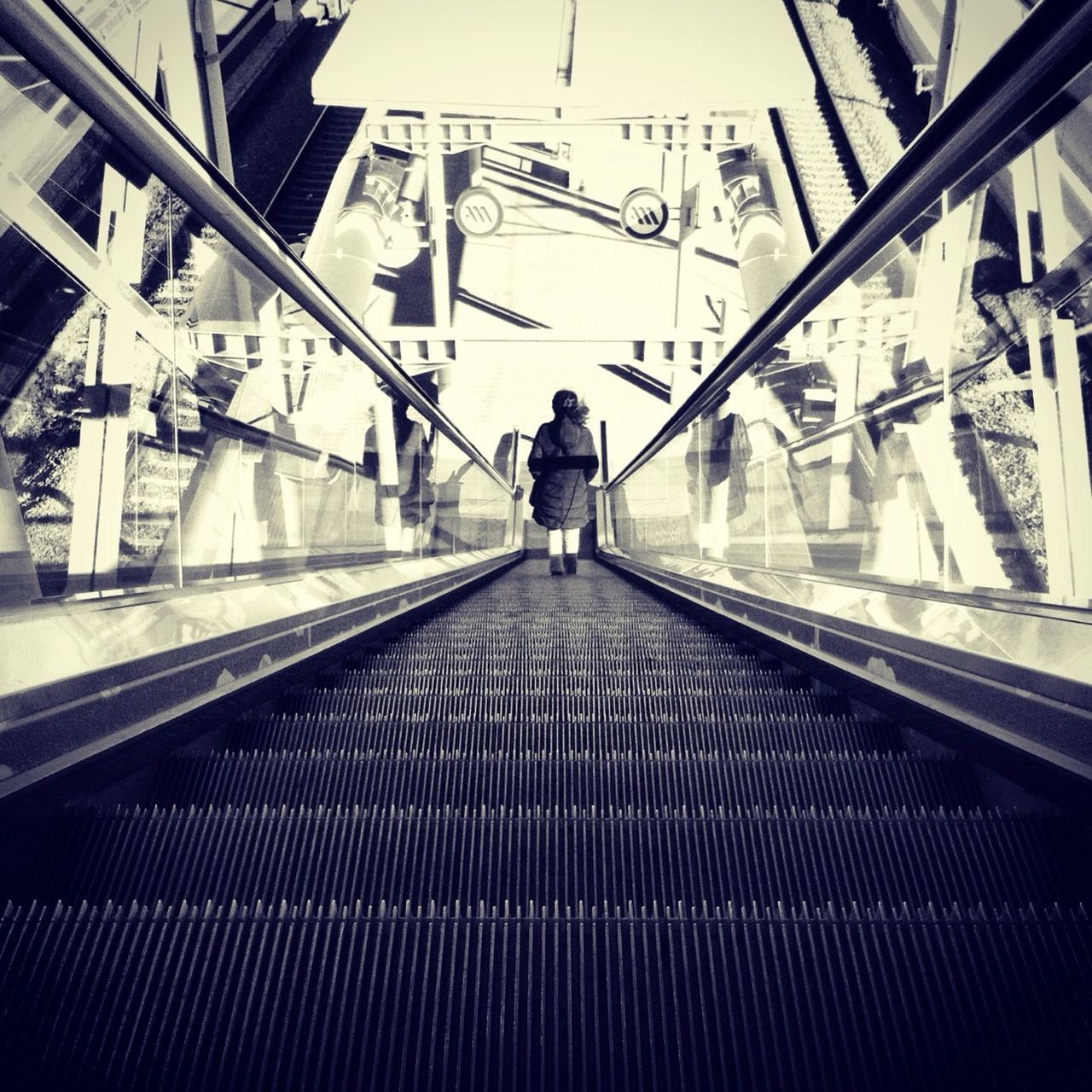 indoors, lifestyles, escalator, architecture, railing, built structure, men, steps, rear view, leisure activity, steps and staircases, person, standing, full length, transportation, the way forward, walking, staircase