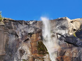 Low angle view of bridal veil falls against clear blue sky at yosemite national park