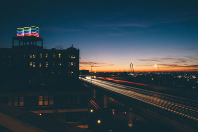 Light trails on urban street along buildings