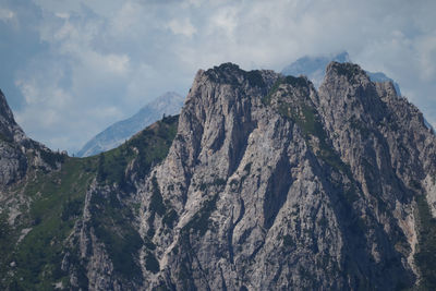 Scenic view of mountains against cloudy sky