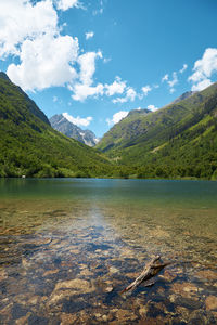 Scenic view of lake and mountains against sky