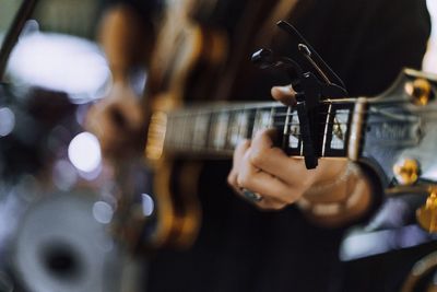 Close-up of man playing guitar
