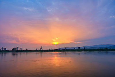 Scenic view of lake against sky during sunset