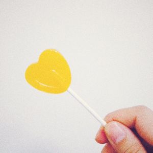 Close-up of cropped hand holding over white background