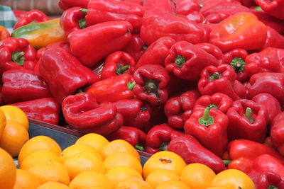 Close-up of bell peppers and oranges for sale at market
