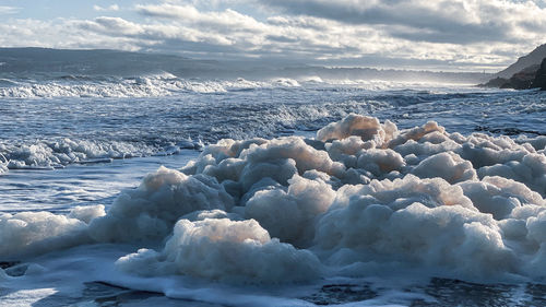 Scenic view of sea against sky during winter