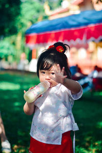 Portrait of young woman standing outdoors