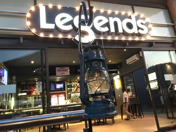 Low angle view of illuminated sign at restaurant