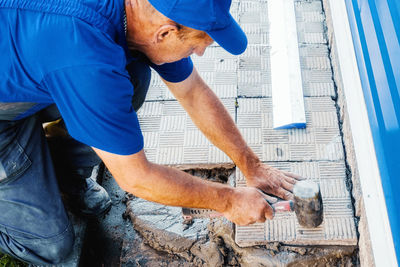 Low section of man standing on footpath