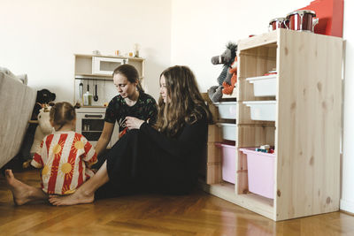 Mother playing with daughter at home