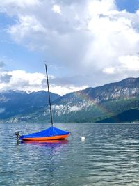 Sailboat in lake against sky