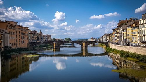 Bridge  florence, over river by buildings against sky in city