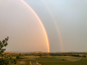 Scenic view of rainbow against sky during sunset