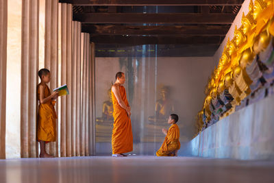 Monk teaching boy in buddhist temple