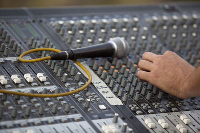 Close-up of hand using sound mixer