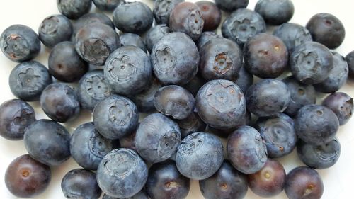 Close-up of blueberries against white background