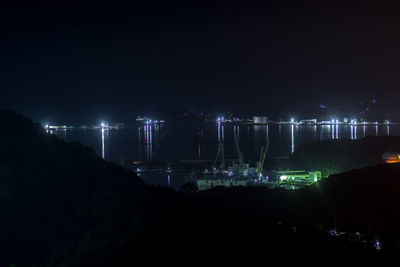 Illuminated city against sky at night