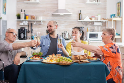 Portrait of smiling friends having food at restaurant