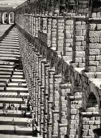 High angle view of people on street by architectural columns