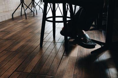 Low section of person on wooden floor