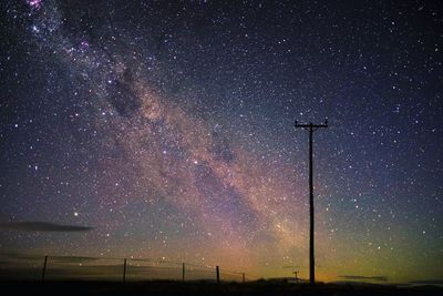 Low angle view of stars on field against sky