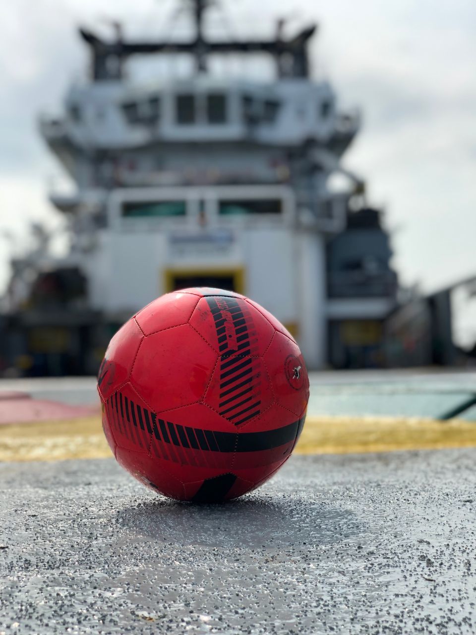 focus on foreground, day, architecture, ball, city, built structure, transportation, building exterior, sport, no people, sphere, close-up, outdoors, nature, building, sky, mode of transportation, red, street, travel