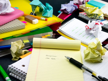 High angle view of text on paper amidst books on table