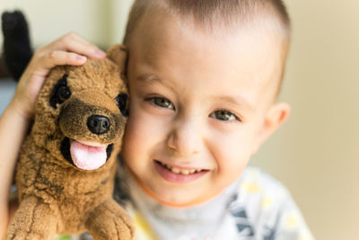 Portrait of cute boy with toy