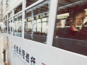 Reflection of train on glass window