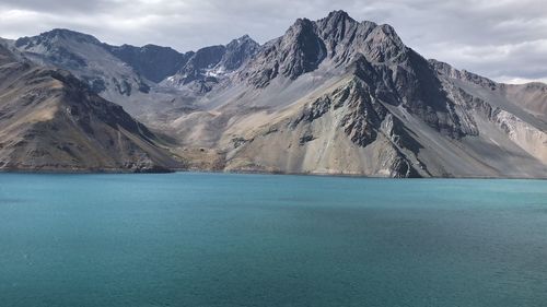 Scenic view of swimming pool by mountains against sky