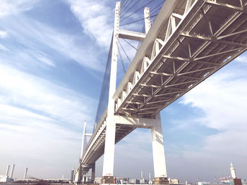 Low angle view of bridge and buildings against sky