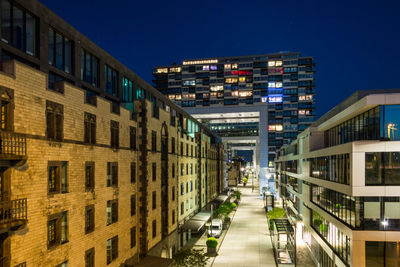 Coloured shot of the illuminated cologne media harbor skyline at night