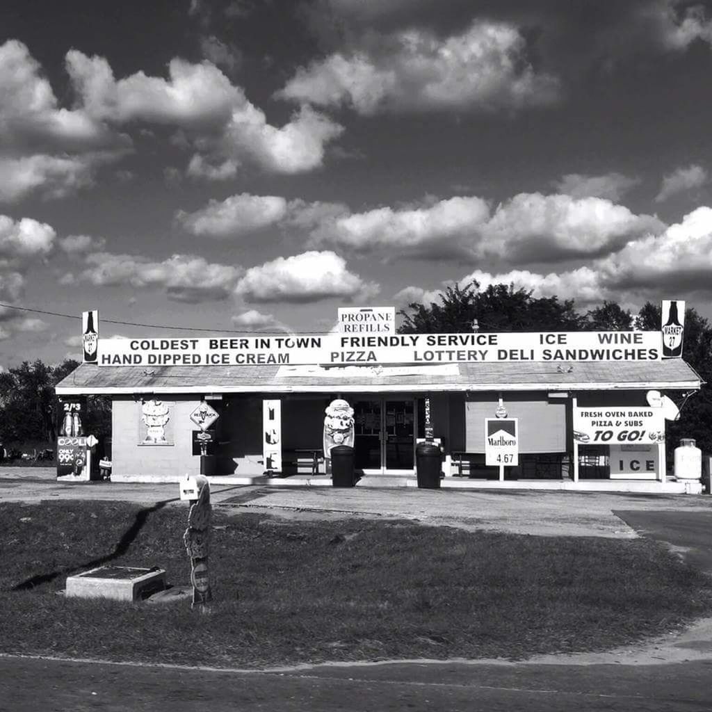 text, western script, architecture, capital letter, built structure, communication, sky, cloud - sky, outdoors, day, building exterior, no people, fuel pump