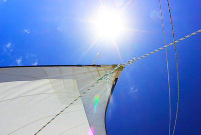 Low angle view of mast against blue sky on sunny day